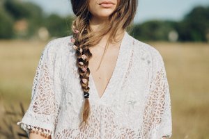 Elegant long bridal plait with dried roses woven in